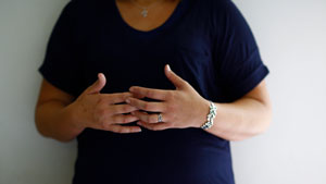 Close-up of woman clutching hands together